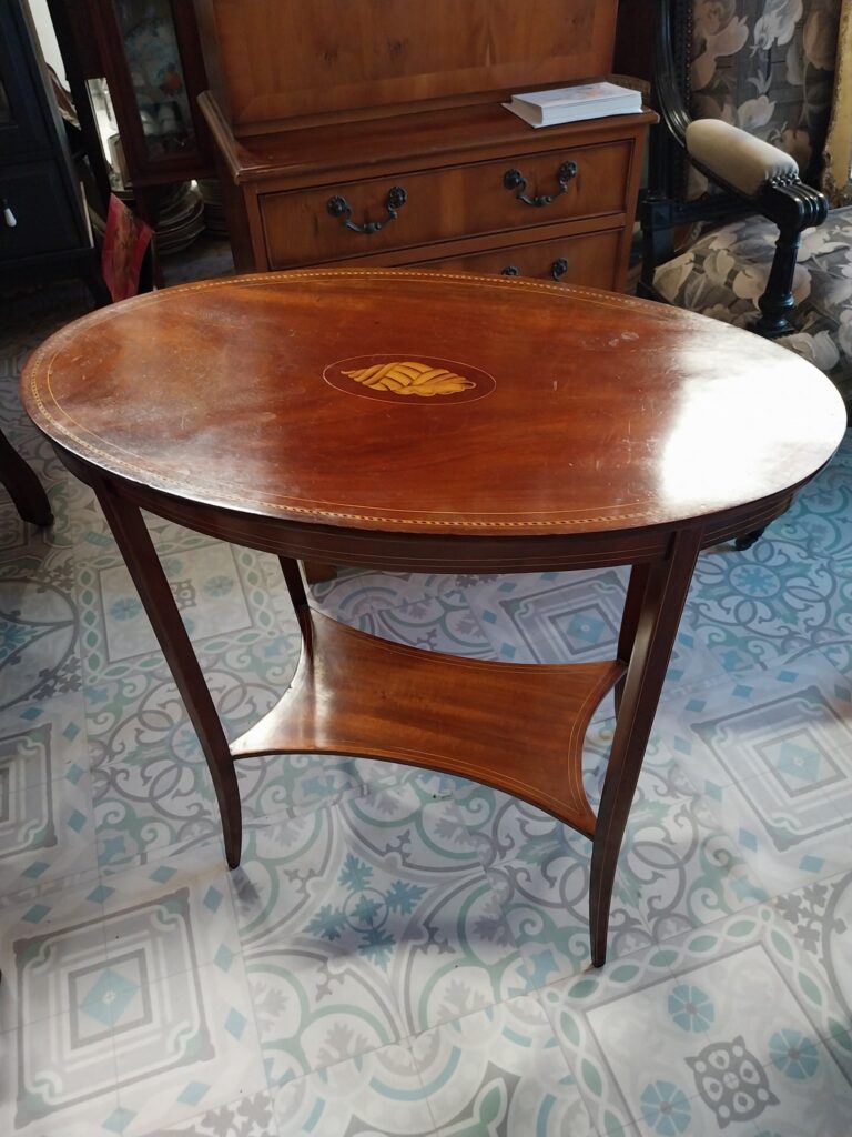 Edwardian Inlaid Mahogany Occasional Table. Oval top with Inlaid Shell Motif with Crossband. Standing on four slender legs with under-tier. Excellent condition €175