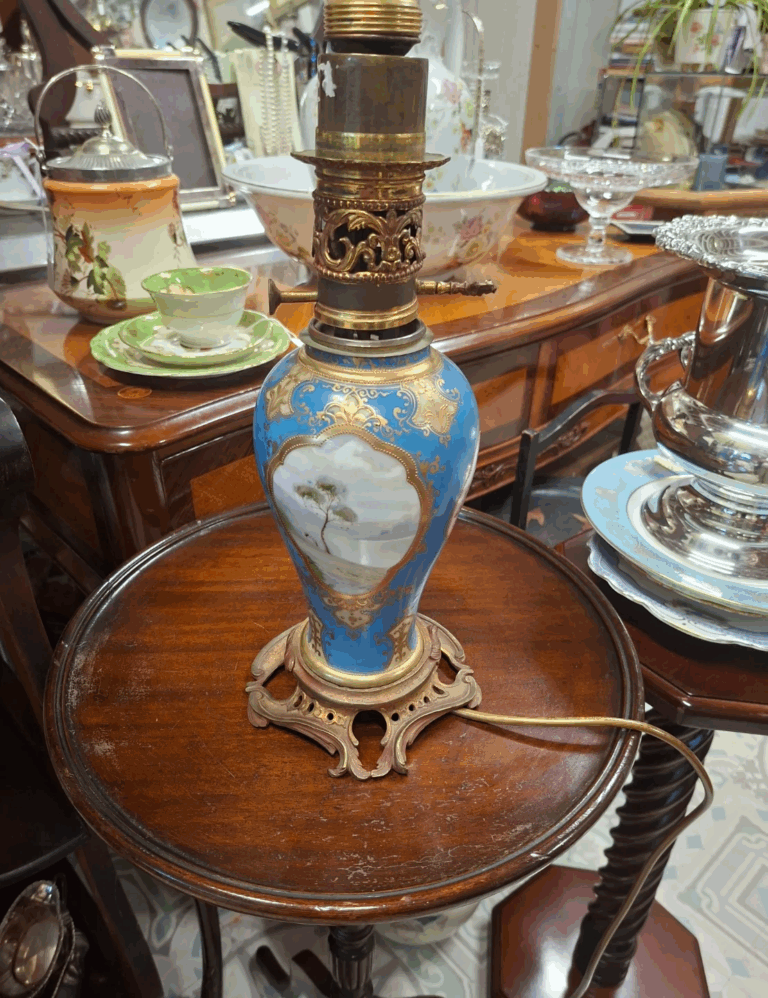 Antique French hand painted porcelain
table lamp on scrolled brass base. Rewired
working. 16" high on 6.5" base