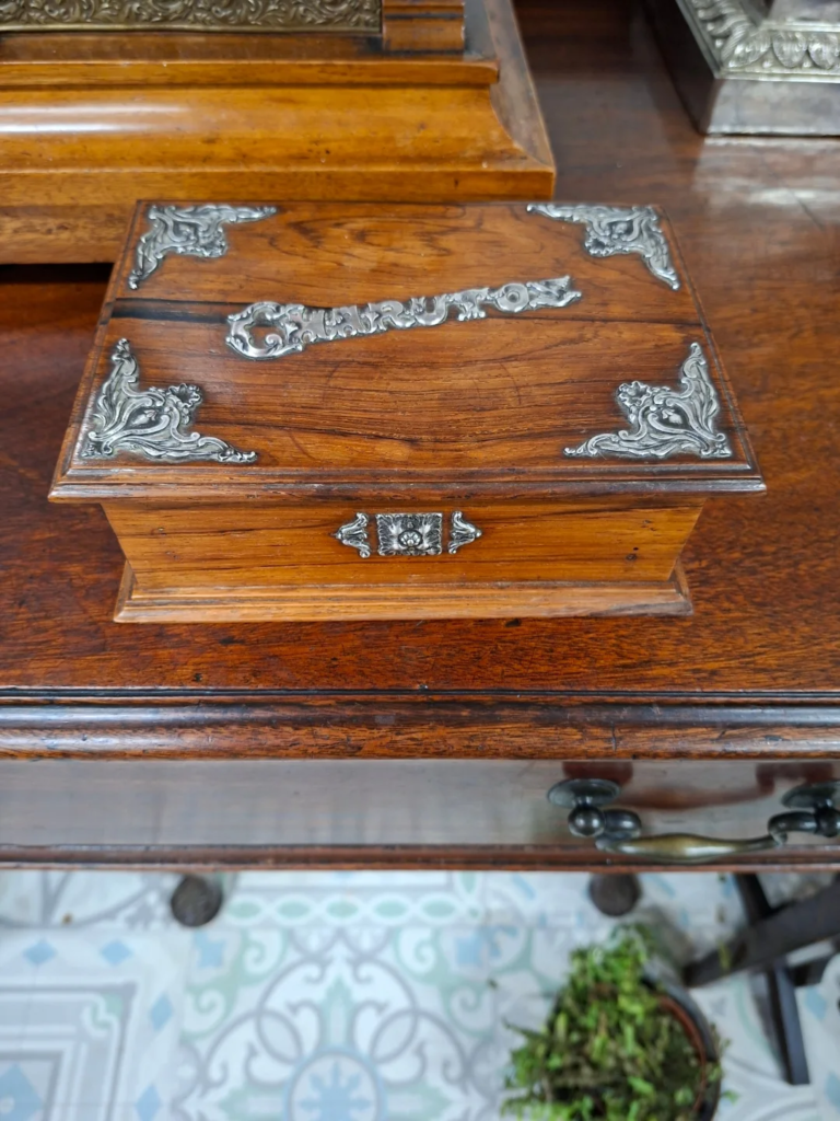 Antique Portuguese Rosewood Cigar Box circa 1920's with Portuguese silver mounts. Measures
7" by 5" by 2" high. Very good condition