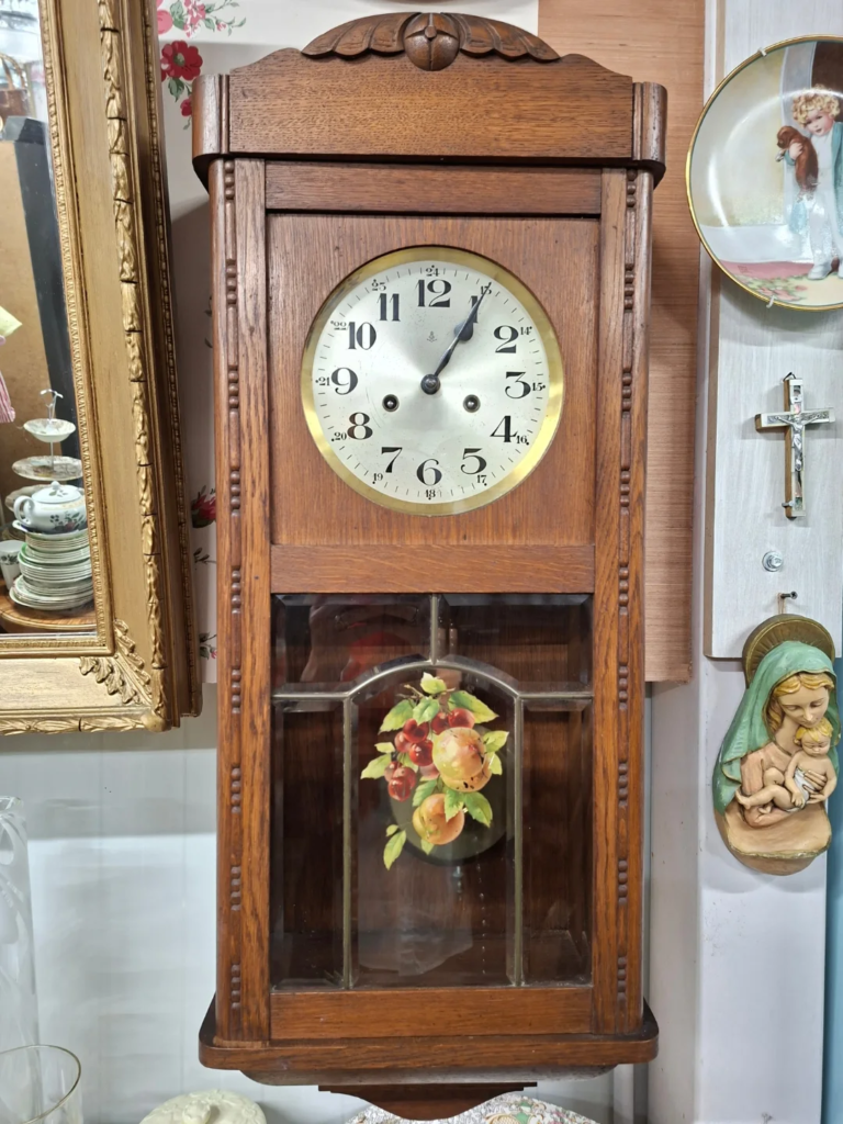 Antique Golden Oak, Arts and Crafts striking wall clock circa 1920s. English movement. The Case with leaded beveled glass panels, hand-painted detail, Portuguese. Measures 32" high, 12" wide by 6.5" deep. Working and in excellent condition.
