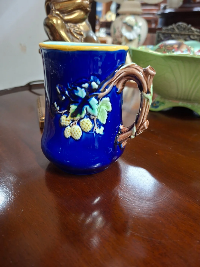 Antique c.1870s Wedgwood Majolica
Mug. Measures 5" by 3.5" Tiny nibble
to top of handle