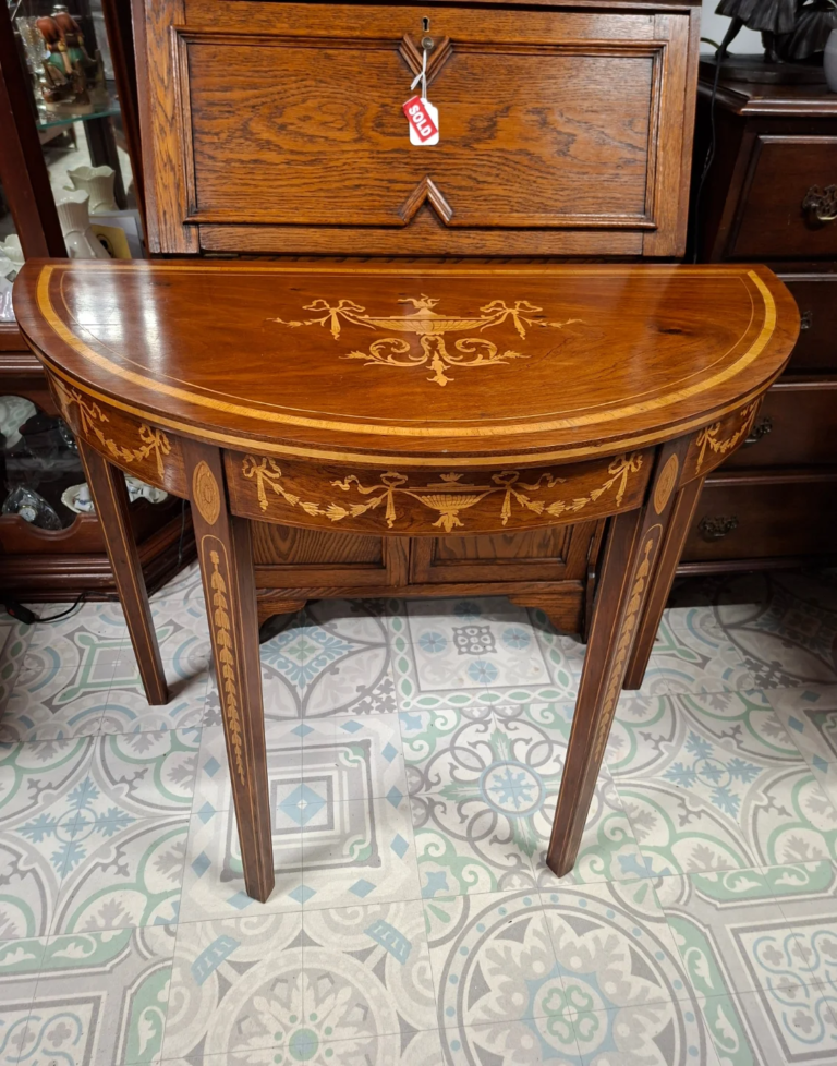 Antique Mahogany and Marquetry Inlaid,
Demilune Console or Hall Table c.1910
Measures 36" wide, 18" deep by 29" high. Very good condition.