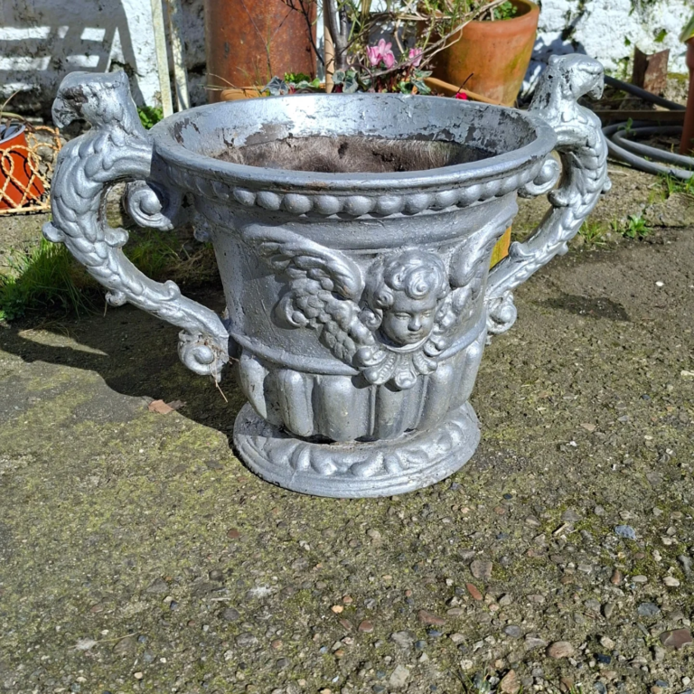 Large Vintage American Composition Planter. Cherub detail with griffin handles. No damage. Measures 22" wide by 14" high
