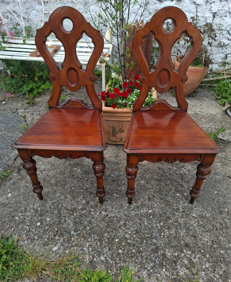 Pair of Antique English Mahogany Hall Chairs. Measures 35" high by 16" wide by 14" deep. Very good condition.
