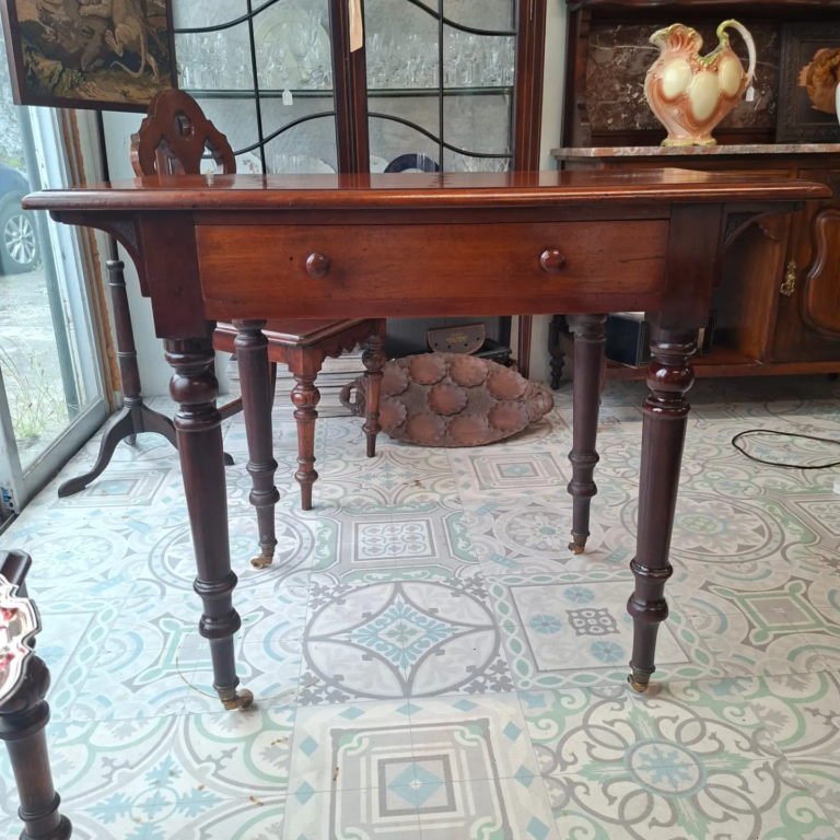 Mid Victorian Mahogany Writing Table/Side Table. 
Turned legs on Original white porcelain castors. 
Measures 35.5" wide by 20" deep, 30" high €295